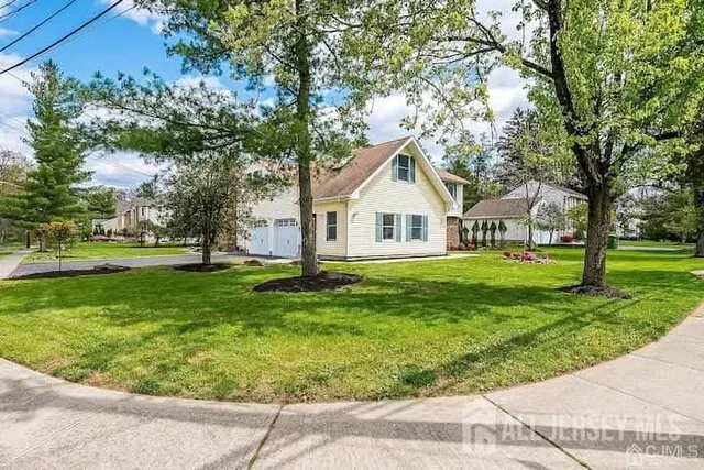 a view of house with a yard