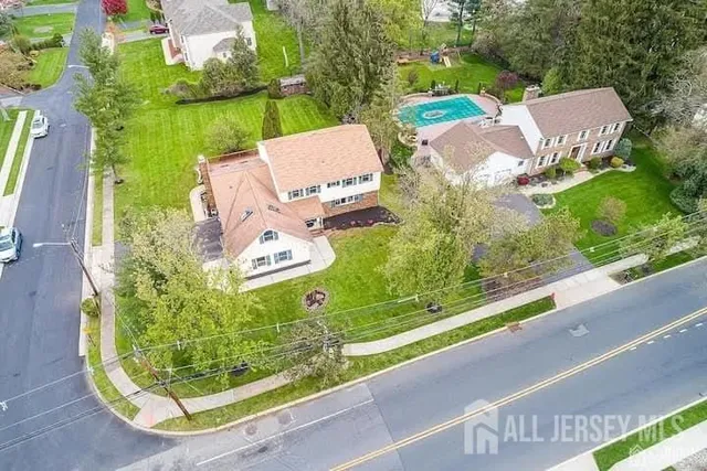 an aerial view of a house with garden space and street view