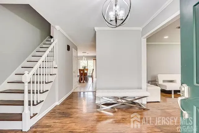 a view of entryway and hall with wooden floor