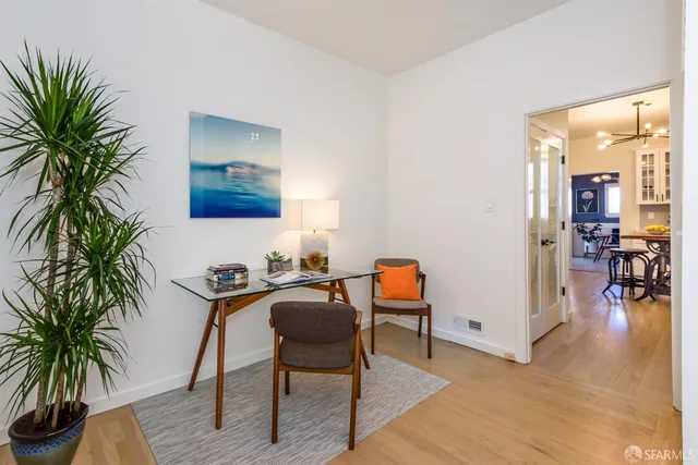 a kitchen with stainless steel appliances a stove a microwave cabinets and a dining table