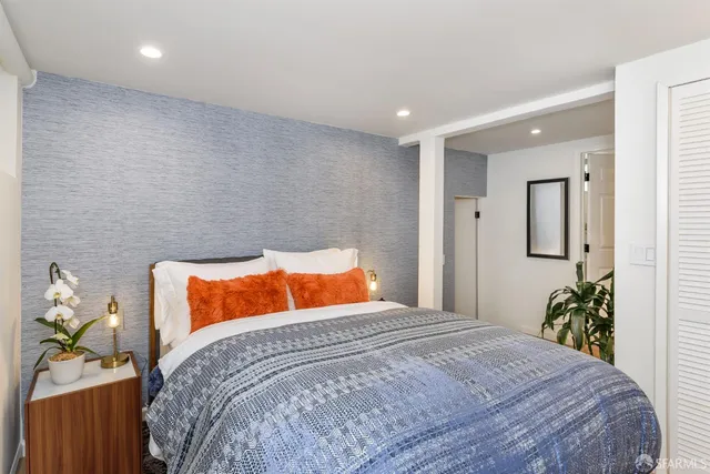 a bedroom with a bed and ceiling fan