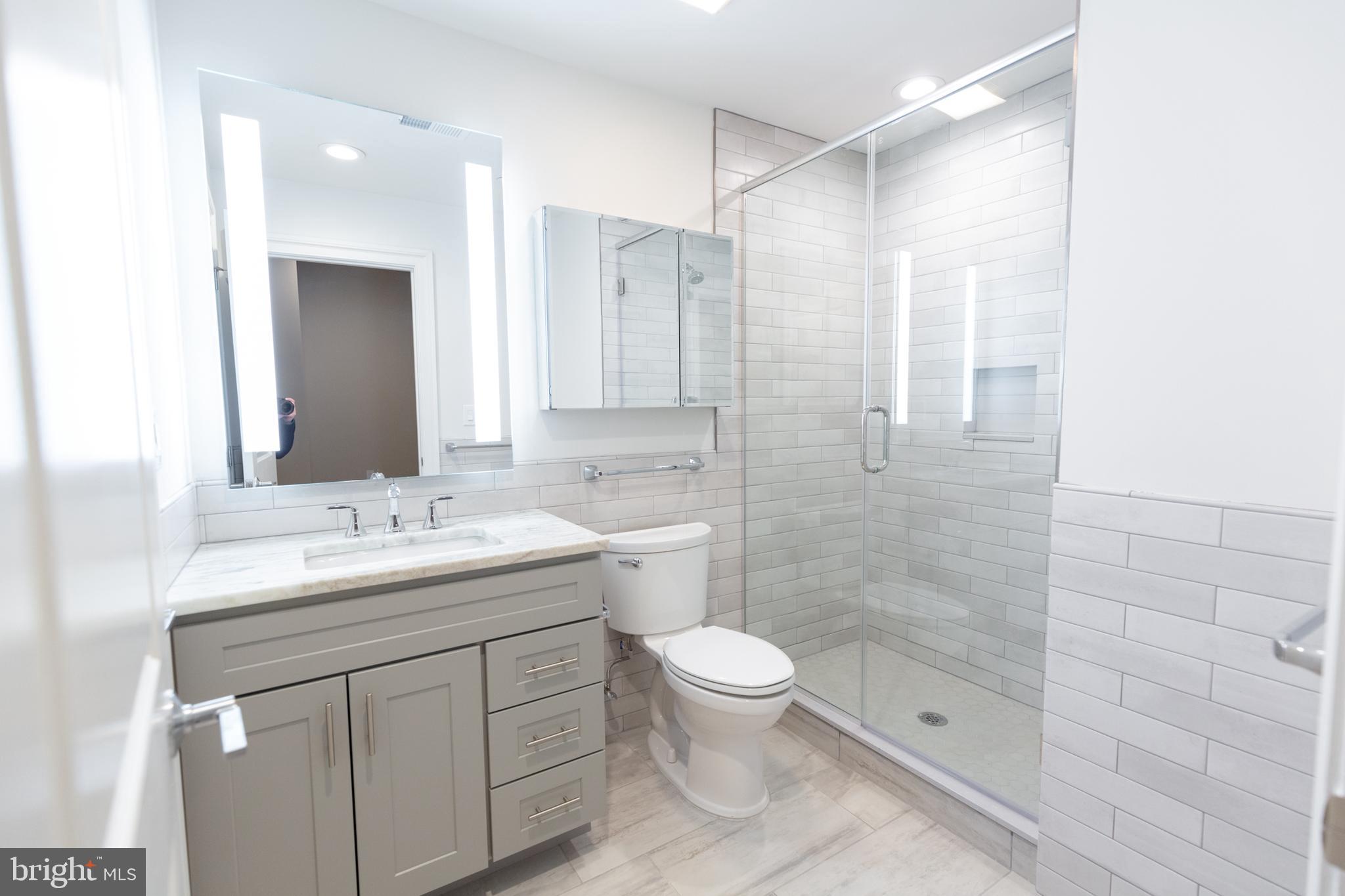 1411-1 Walnut Street, Unit 201 Philadelphia, PA 19102 - Photo 23 of 27 a bathroom with a sink a toilet and shower