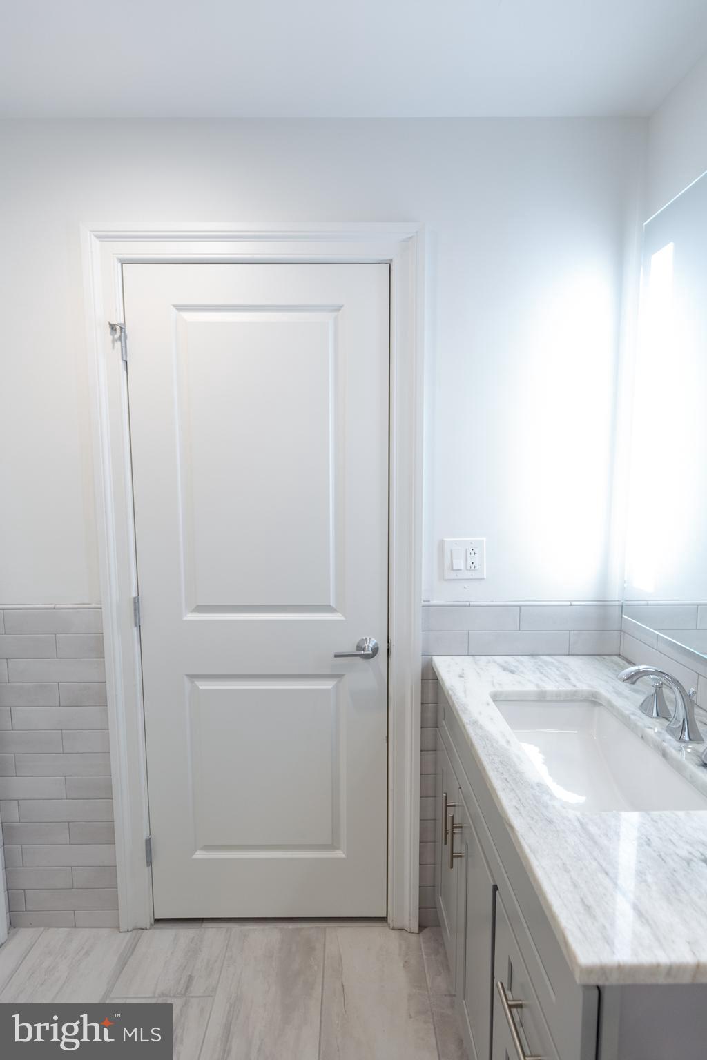 1411-1 Walnut Street, Unit 201 Philadelphia, PA 19102 - Photo 24 of 27 a bathroom with a sink and a mirror