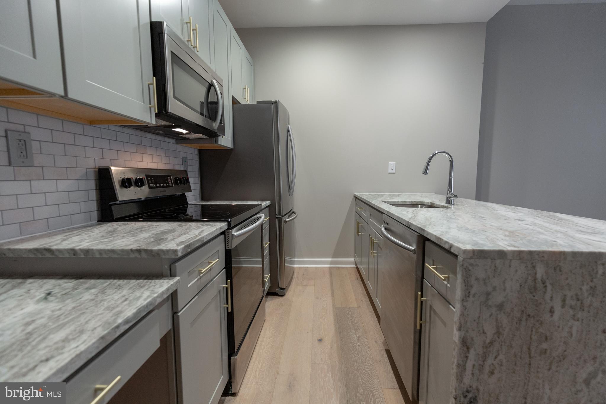 1411-1 Walnut Street, Unit 201 Philadelphia, PA 19102 - Photo 7 of 27 a kitchen with a sink stove and refrigerator