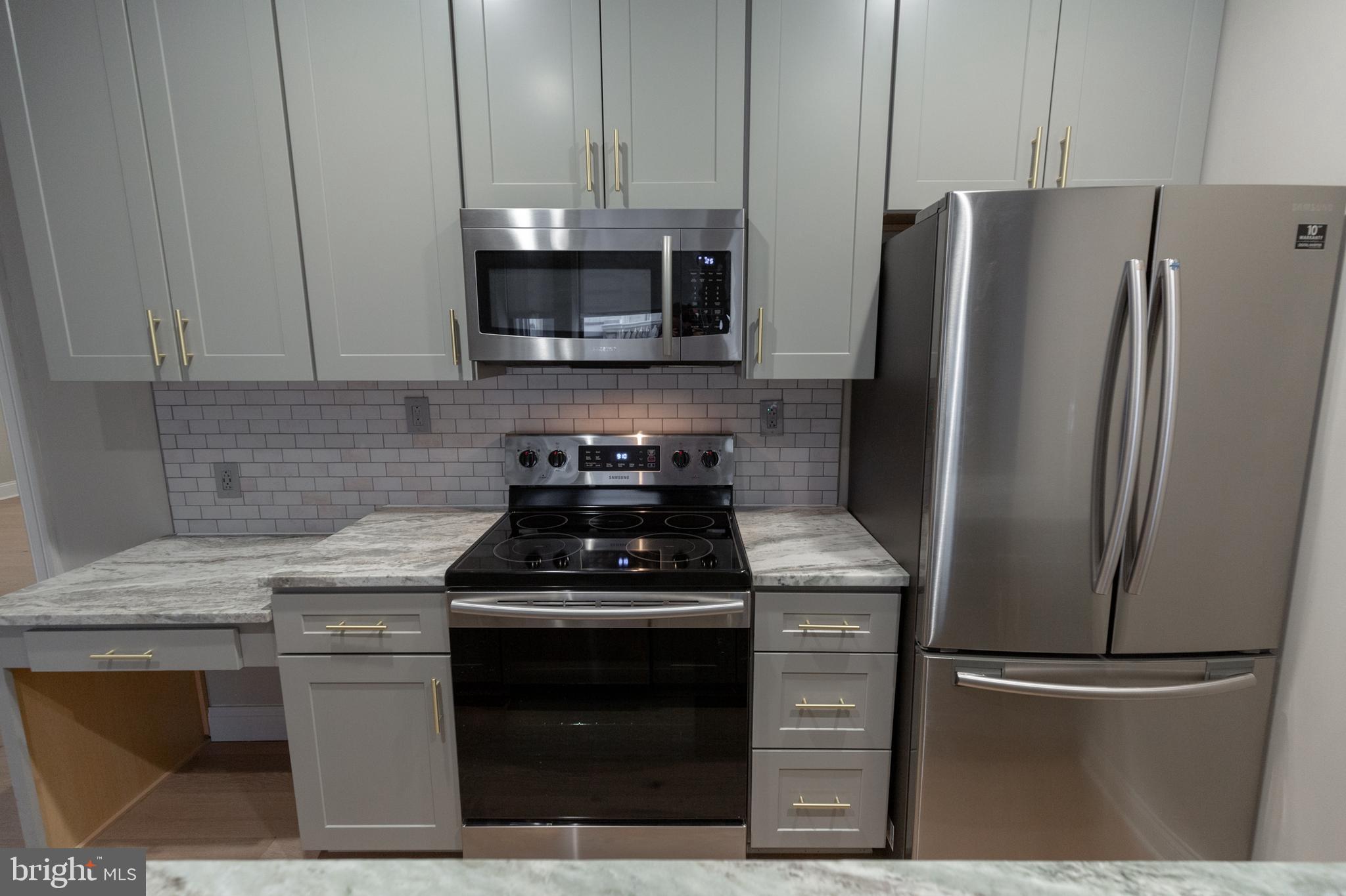 1411-1 Walnut Street, Unit 201 Philadelphia, PA 19102 - Photo 8 of 27 a kitchen with a stainless steel appliances and cabinets