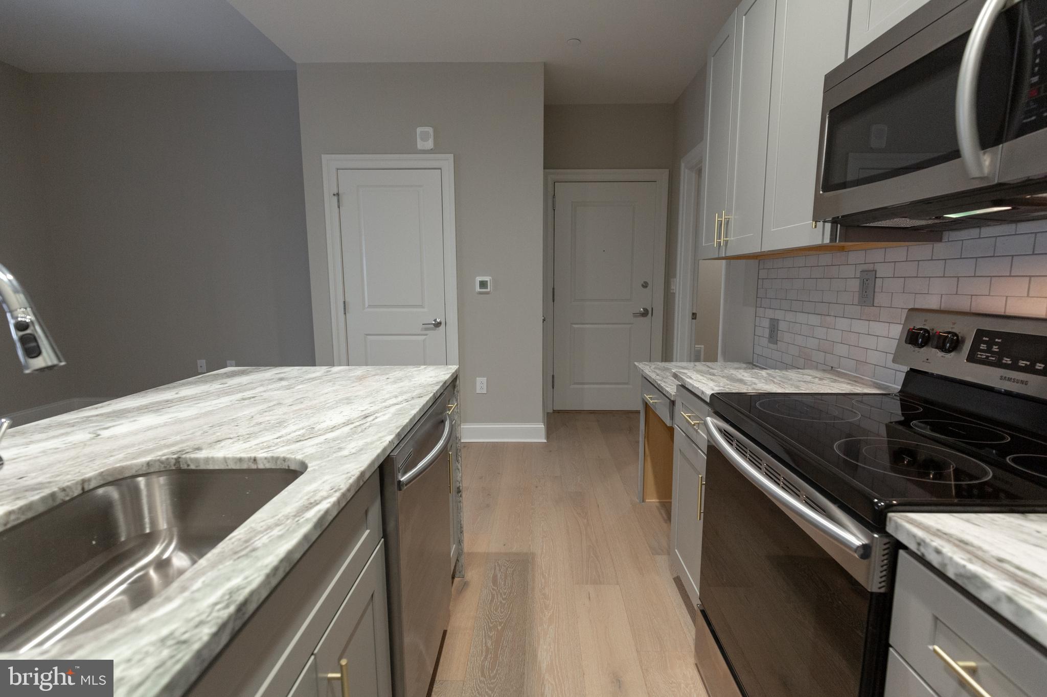 1411-1 Walnut Street, Unit 201 Philadelphia, PA 19102 - Photo 10 of 27 a kitchen that has a sink and a stove