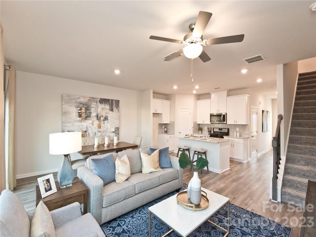 2235 Belterra Drive Charlotte, NC 28216 - Photo 3 of 8 a living room with furniture kitchen view and a chandelier