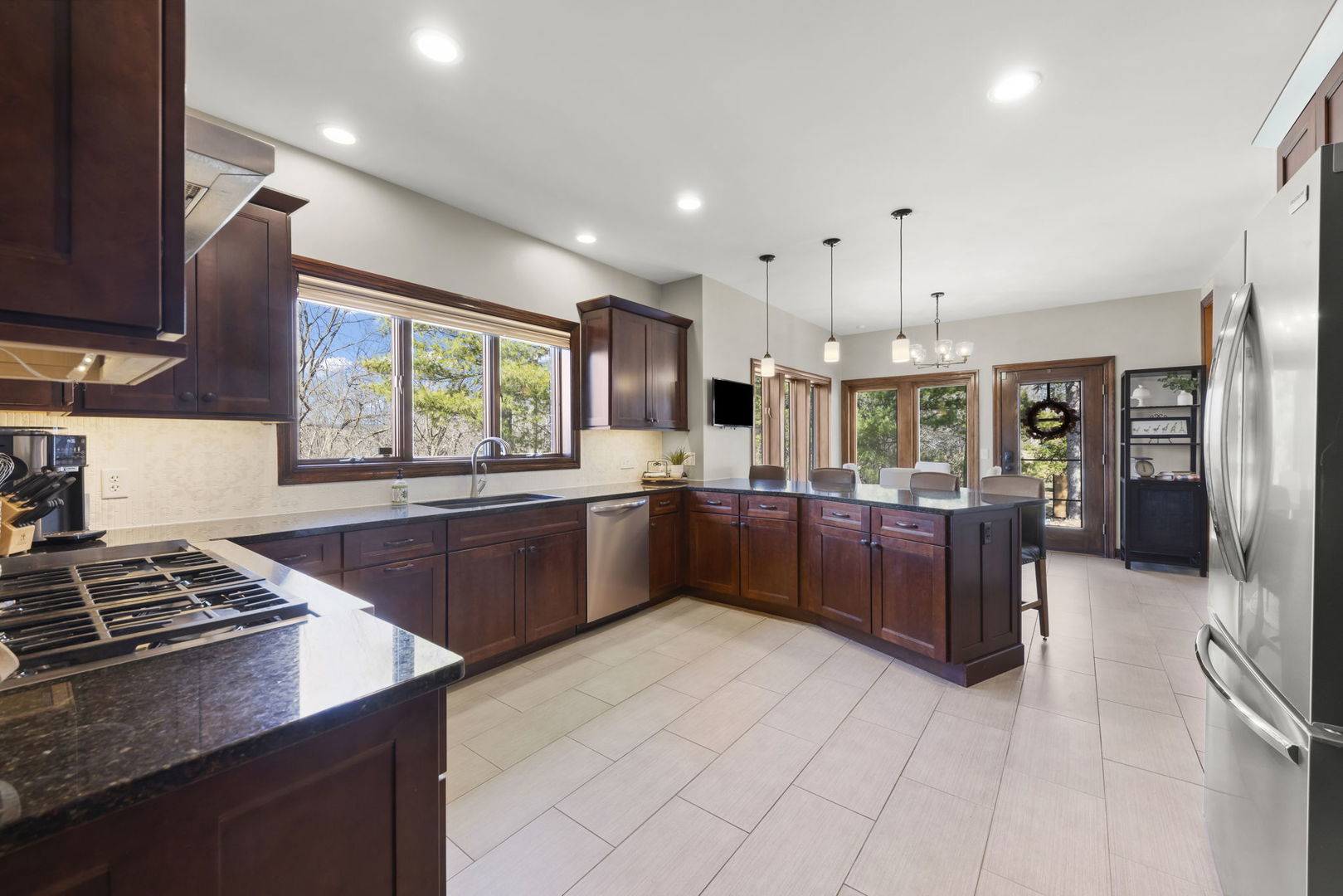 8877 Kennedy Road Yorkville, IL 60560 - Photo 16 of 86 a kitchen with stainless steel appliances kitchen island granite countertop a sink and cabinets