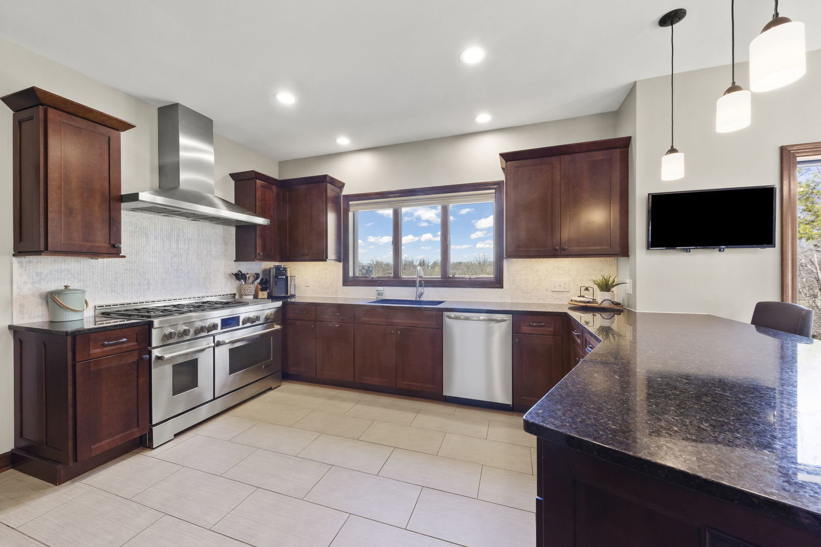 8877 Kennedy Road Yorkville, IL 60560 - Photo 18 of 86 a kitchen with stainless steel appliances granite countertop a stove a sink and a microwave
