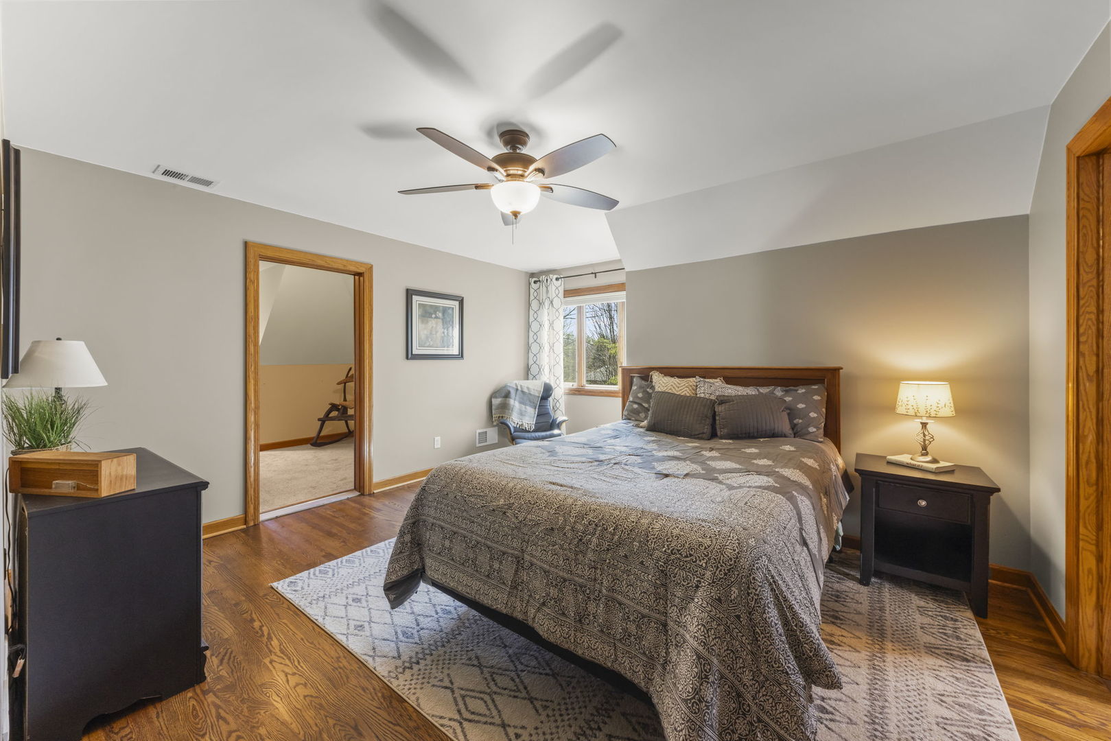 8877 Kennedy Road Yorkville, IL 60560 - Photo 39 of 86 a spacious bedroom with a bed and a chandelier