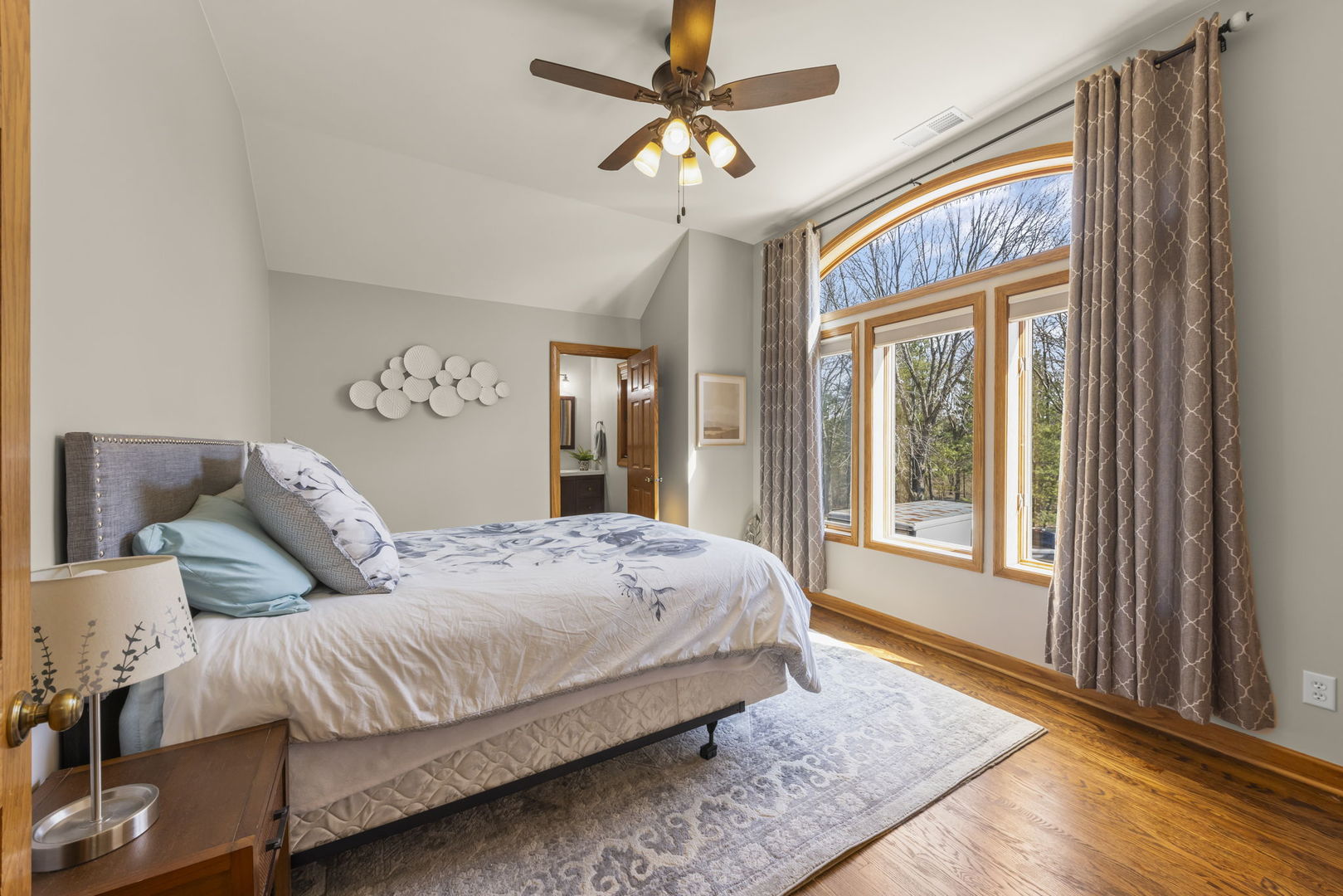 8877 Kennedy Road Yorkville, IL 60560 - Photo 43 of 86 a bedroom with a large bed and a chandelier