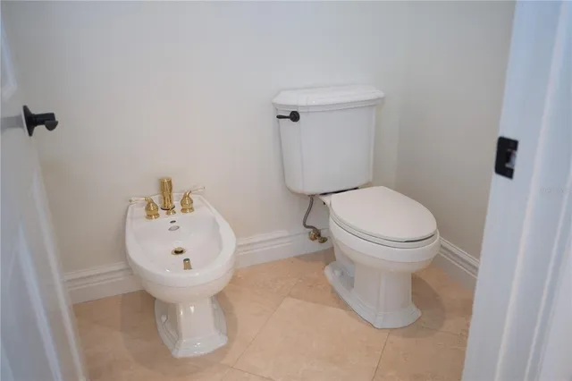 a bathroom with a sink toilet and a mirror