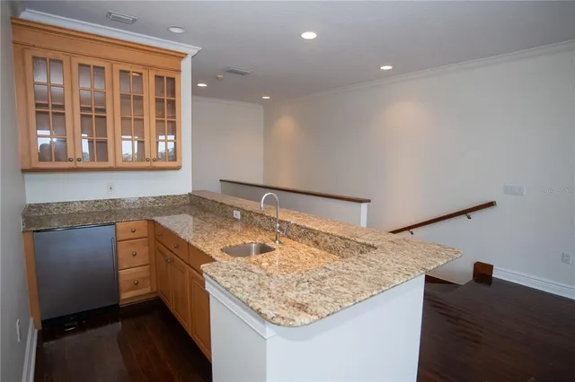 a kitchen with a sink stove and cabinets