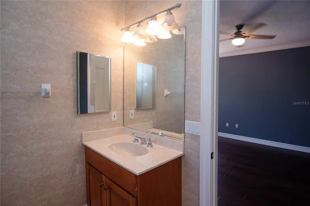 a bathroom with a sink a mirror and a light fixture