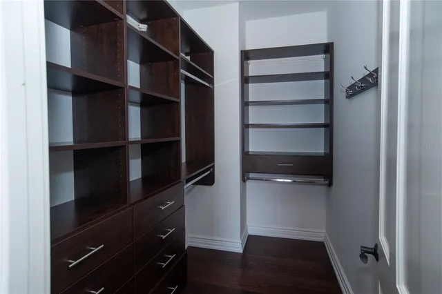 a view of walk in closet with empty racks