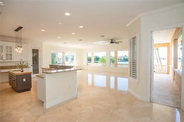 a open kitchen with white cabinets and white appliances