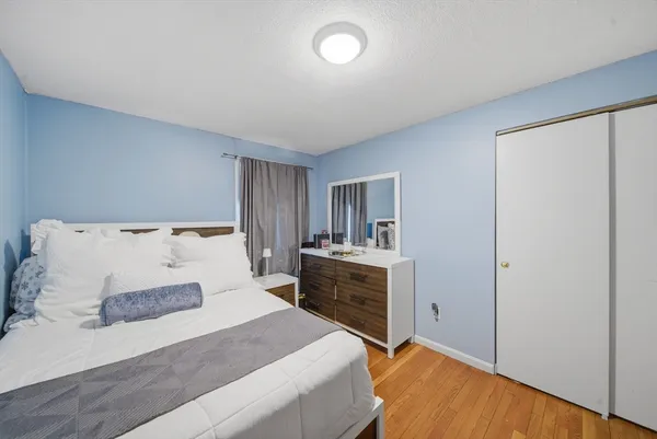 a bedroom with a large bed and a closet