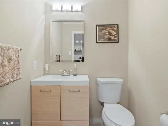 a bathroom with a toilet a sink and mirror
