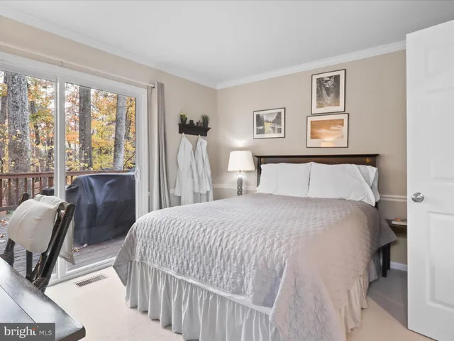 a bedroom with a bed a couch and a window