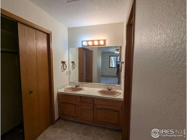a bathroom with a granite countertop shower and a toilet