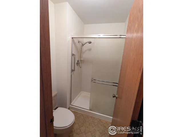 a view of a hallway with a bathroom