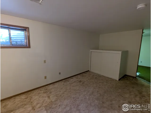 a view of a livingroom with a ceiling fan and window