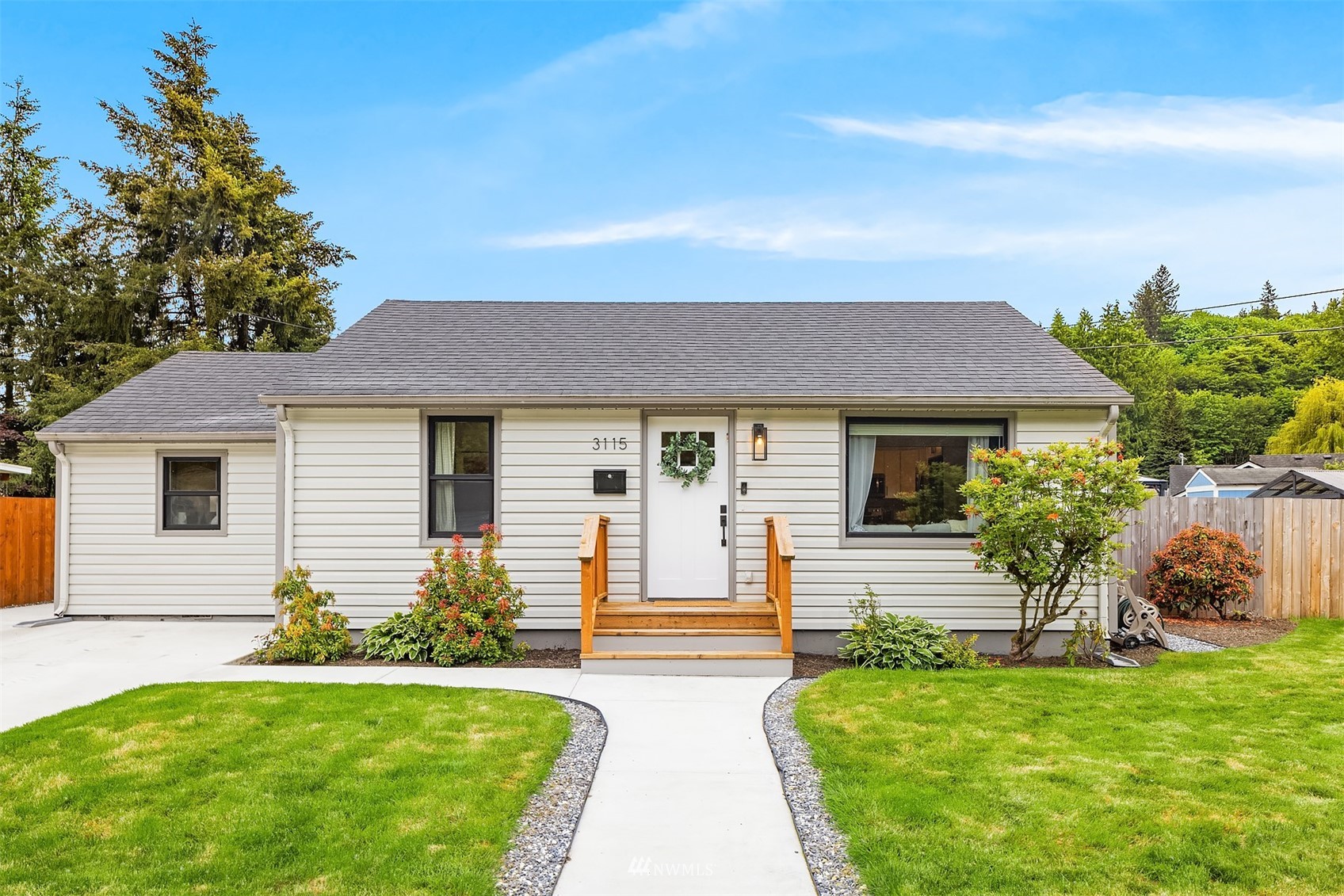 3115 Southeast 5th Street Renton, WA 98058 - Photo 1 of 25 a front view of a house with a yard