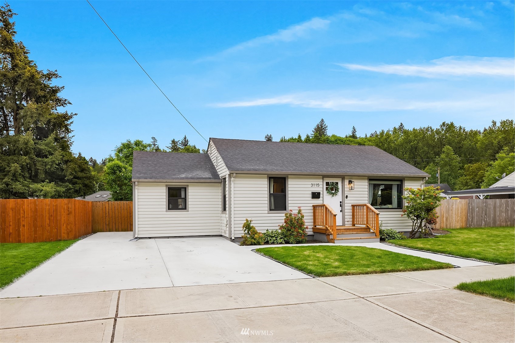 3115 Southeast 5th Street Renton, WA 98058 - Photo 2 of 25 a front view of a house with a yard and garage