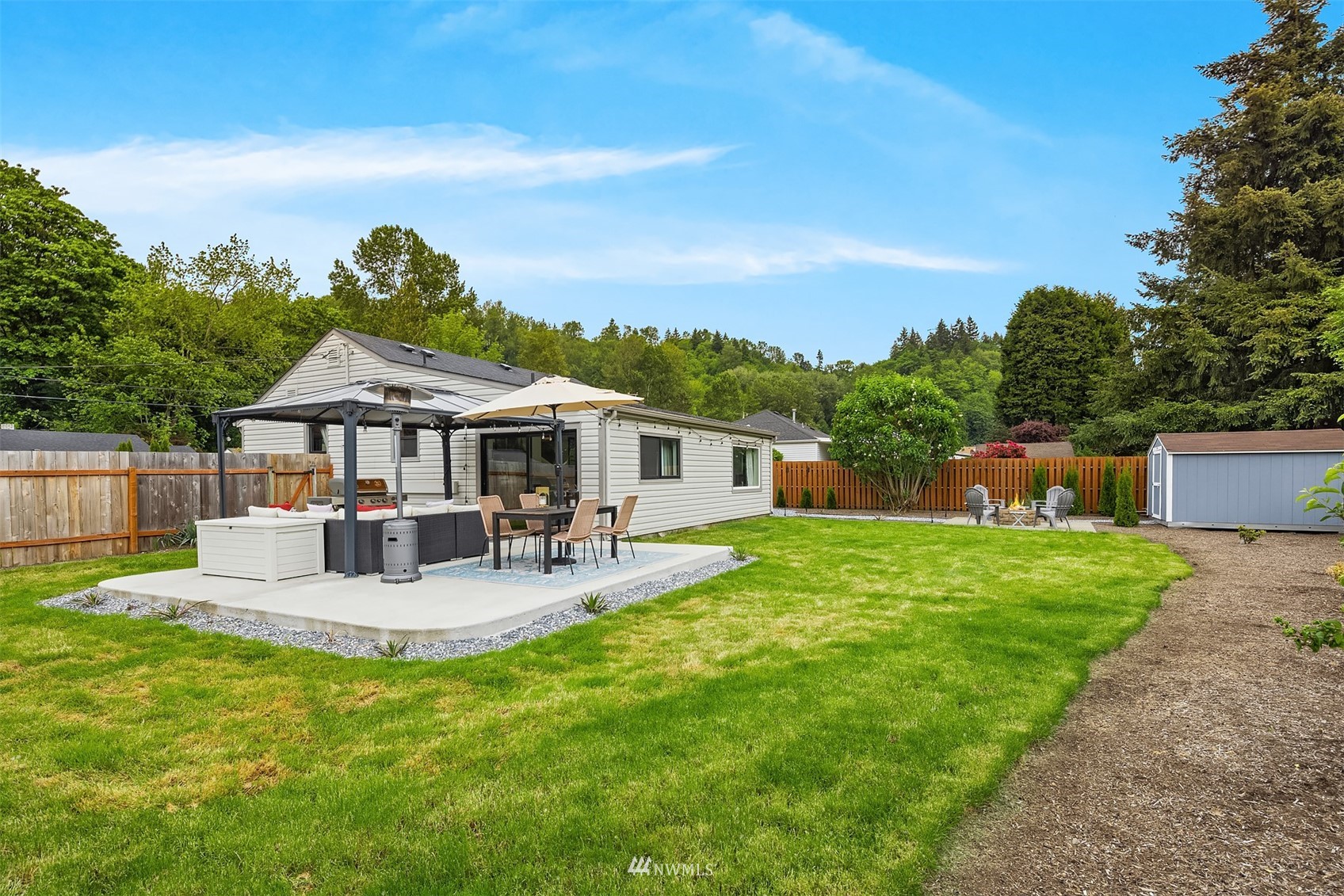 3115 Southeast 5th Street Renton, WA 98058 - Photo 23 of 25 a view of house with backyard and outdoor seating