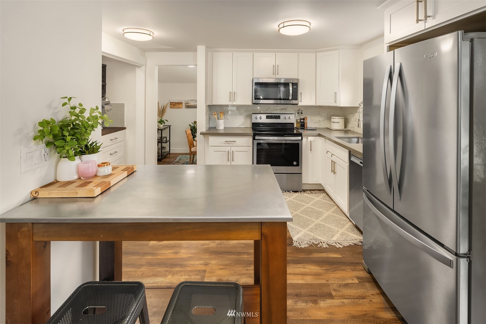 3115 Southeast 5th Street Renton, WA 98058 - Photo 8 of 25 a kitchen with kitchen island a counter appliances a sink and cabinets