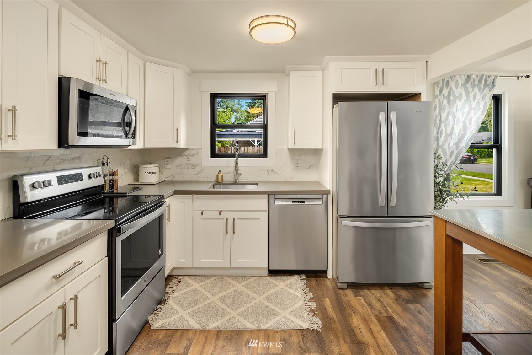 3115 Southeast 5th Street Renton, WA 98058 - Photo 9 of 25 a kitchen with a refrigerator sink and microwave
