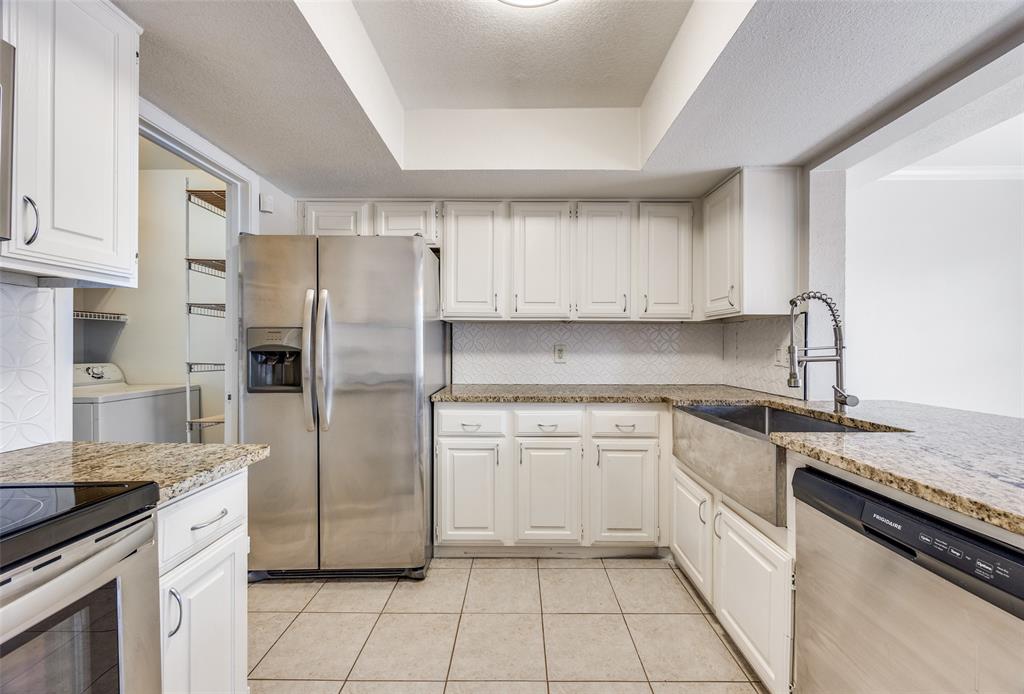 13220 Woodbend Lane Dallas, TX 75243 - Photo 11 of 26 a kitchen with stainless steel appliances granite countertop a refrigerator sink and cabinets