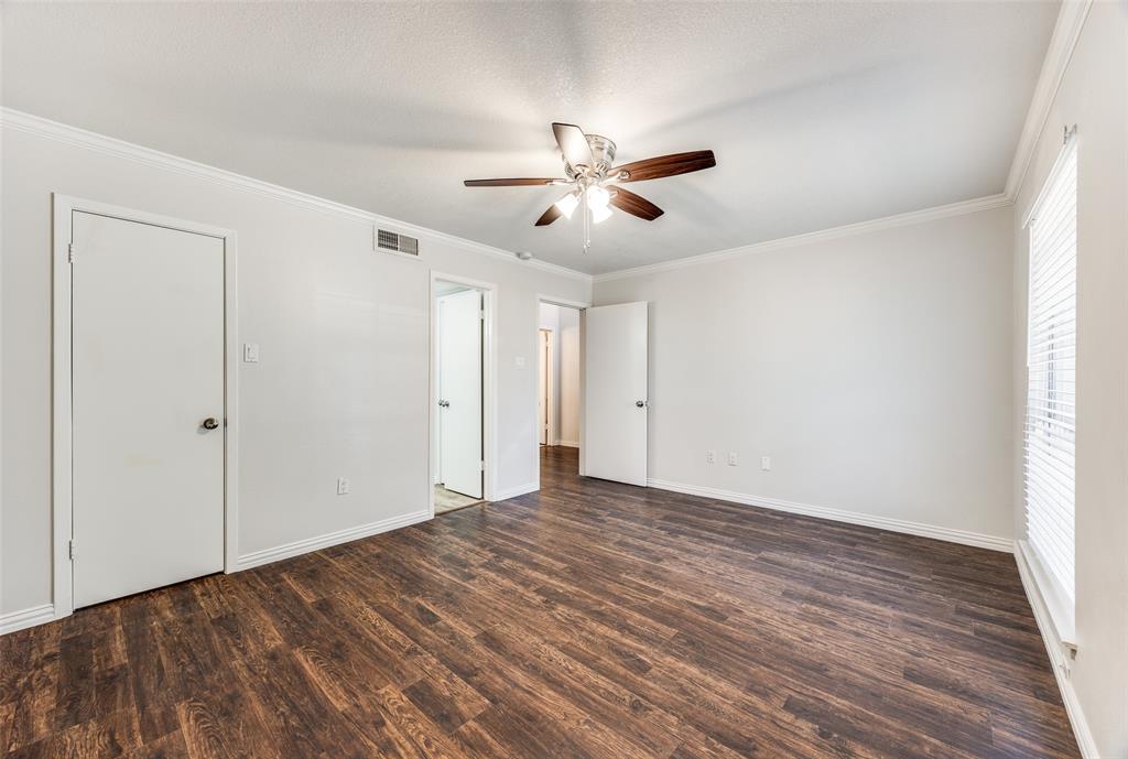 13220 Woodbend Lane Dallas, TX 75243 - Photo 16 of 26 a view of empty room with wooden floor and fan