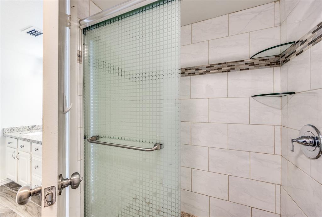 13220 Woodbend Lane Dallas, TX 75243 - Photo 18 of 26 a bathroom with a shower