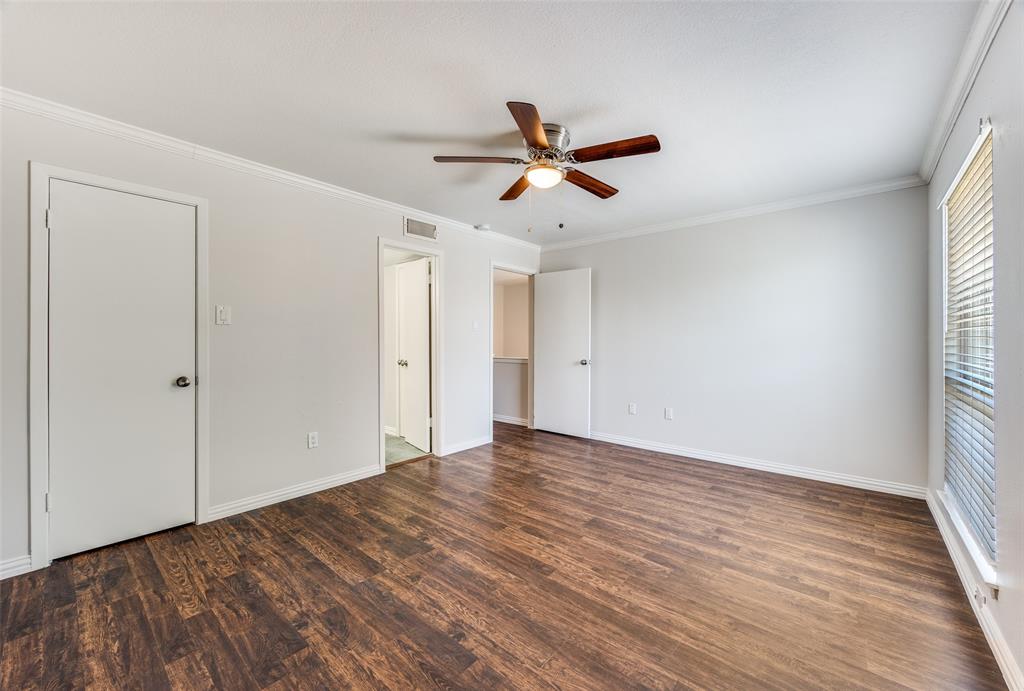13220 Woodbend Lane Dallas, TX 75243 - Photo 22 of 26 a view of empty room with wooden floor and fan