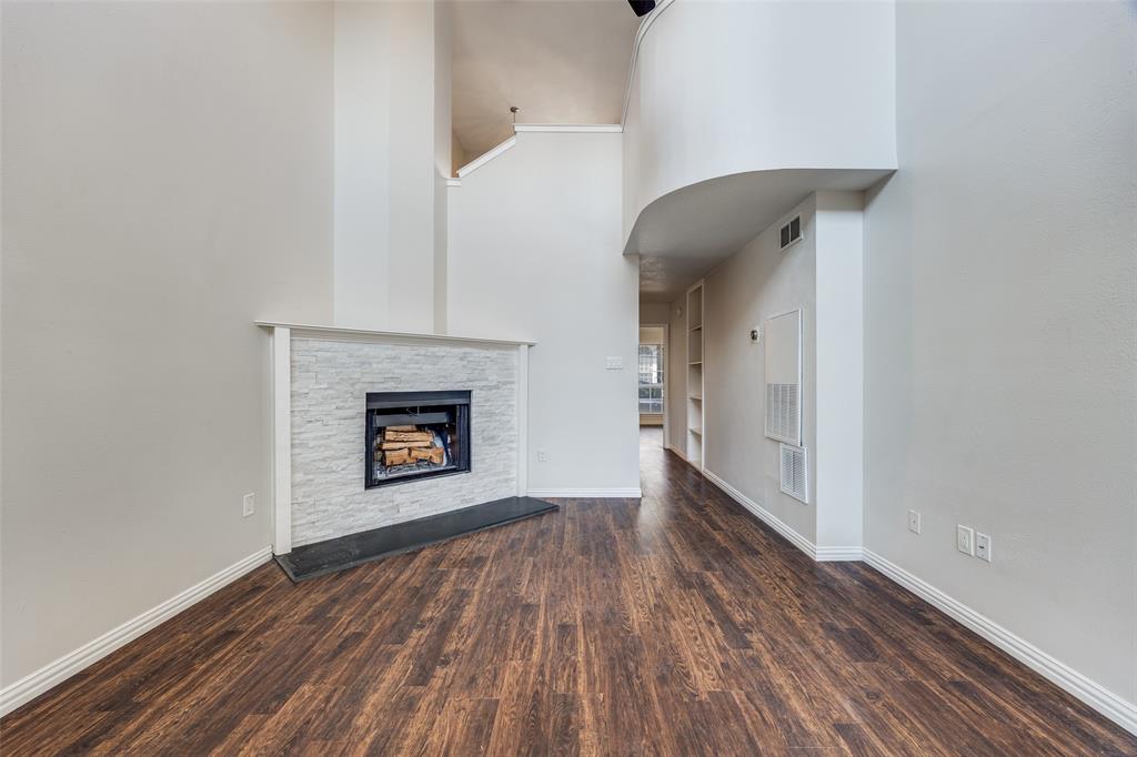 13220 Woodbend Lane Dallas, TX 75243 - Photo 4 of 26 a view of an empty room with a fireplace and a window