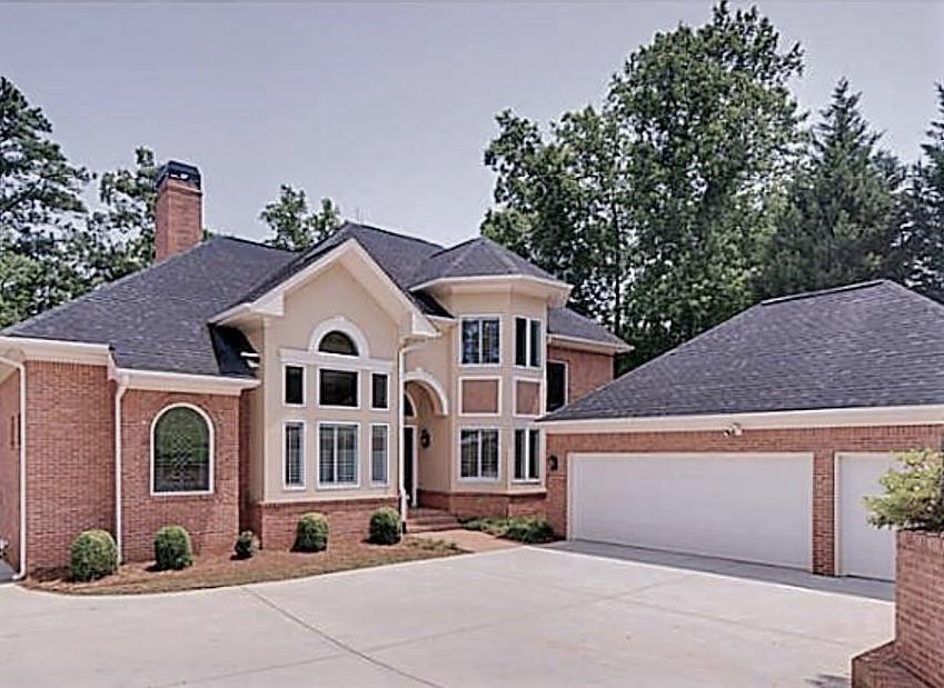 6489 Old Shadburn Ferry Road Buford, GA 30518 - Photo 1 of 1 a front view of a house with a yard