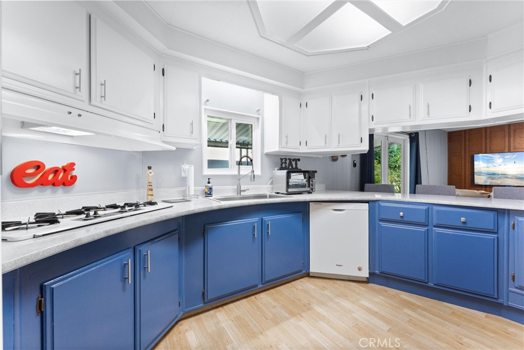 1400 Sunkist, Unit 173 Anaheim, CA 92806 - Photo 1 of 42 a kitchen with stainless steel appliances granite countertop a sink dishwasher and cabinets with wooden floor