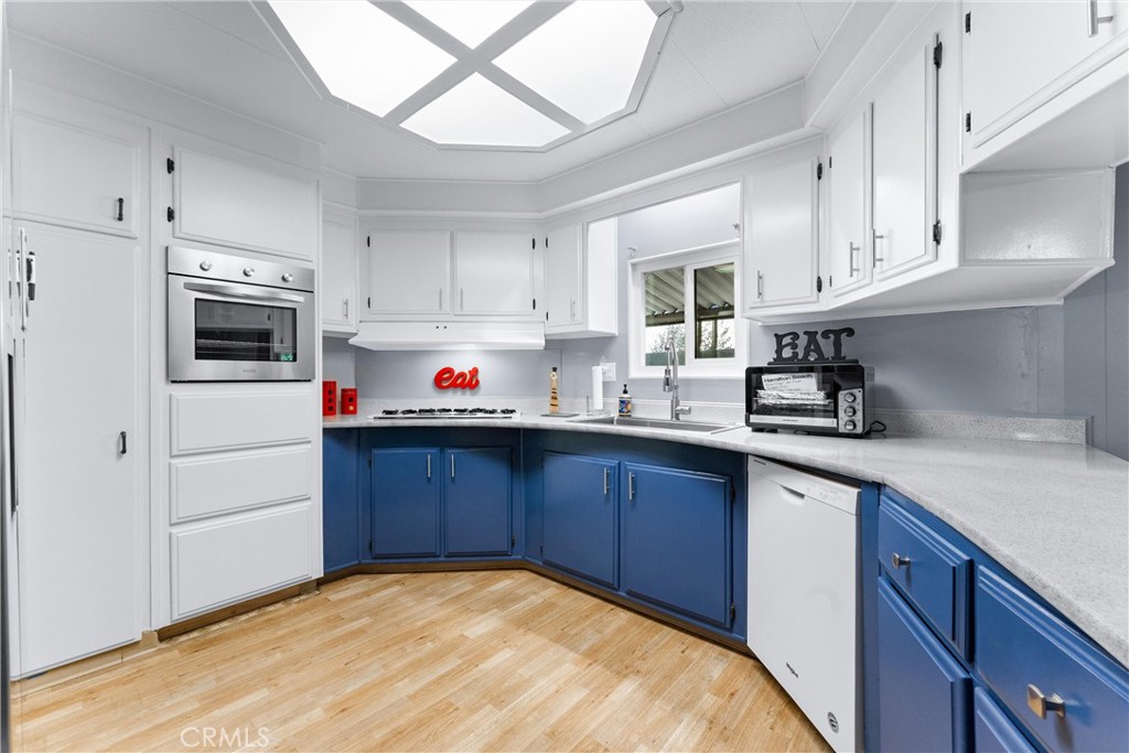 1400 Sunkist, Unit 173 Anaheim, CA 92806 - Photo 14 of 42 a kitchen with stainless steel appliances granite countertop a sink dishwasher a stove and a refrigerator with cabinets