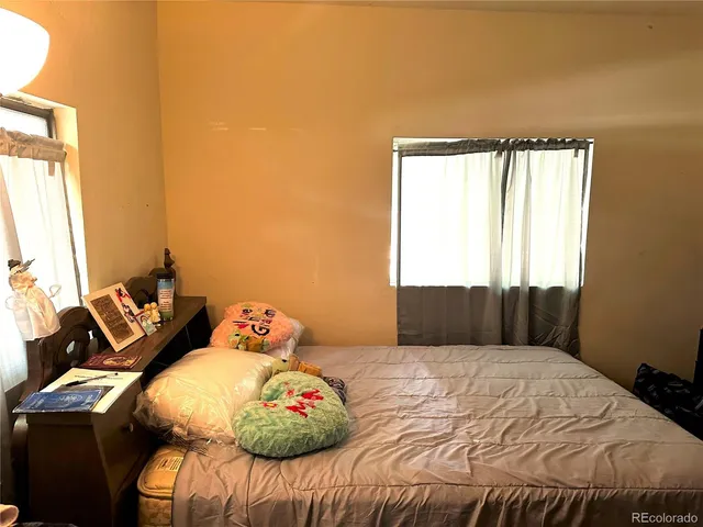 a bedroom with a bed and window