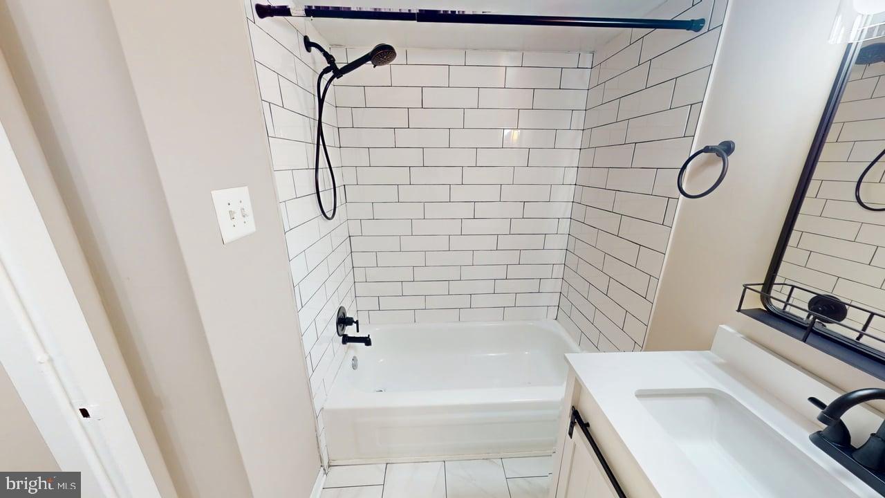 10114 Campus Way South, Unit 201 8C Upper Marlboro, MD 20774 - Photo 16 of 17 a bathroom with a bathtub and shower
