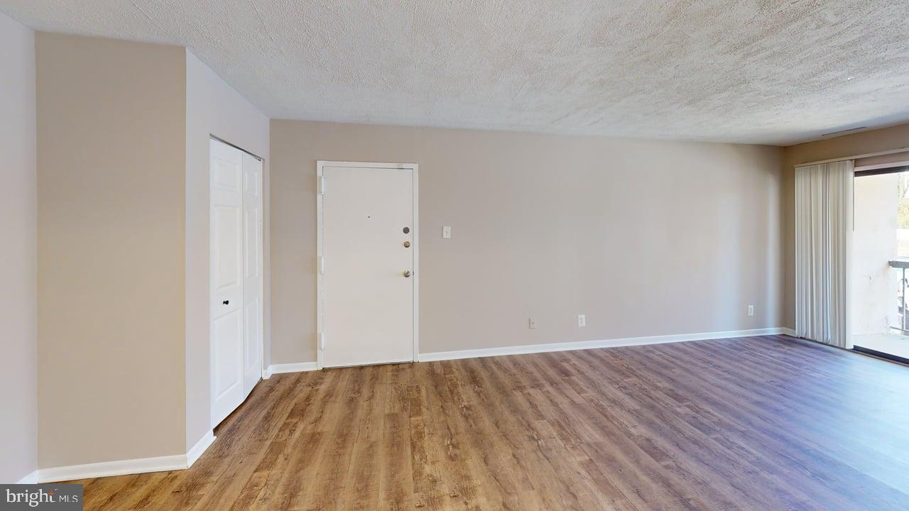 10114 Campus Way South, Unit 201 8C Upper Marlboro, MD 20774 - Photo 17 of 17 a view of an empty room with wooden floor
