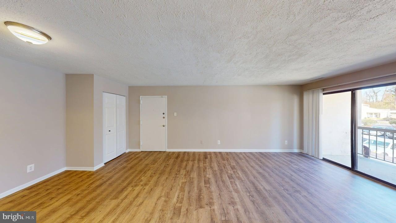 10114 Campus Way South, Unit 201 8C Upper Marlboro, MD 20774 - Photo 2 of 17 a view of a room with wooden floor and large windows