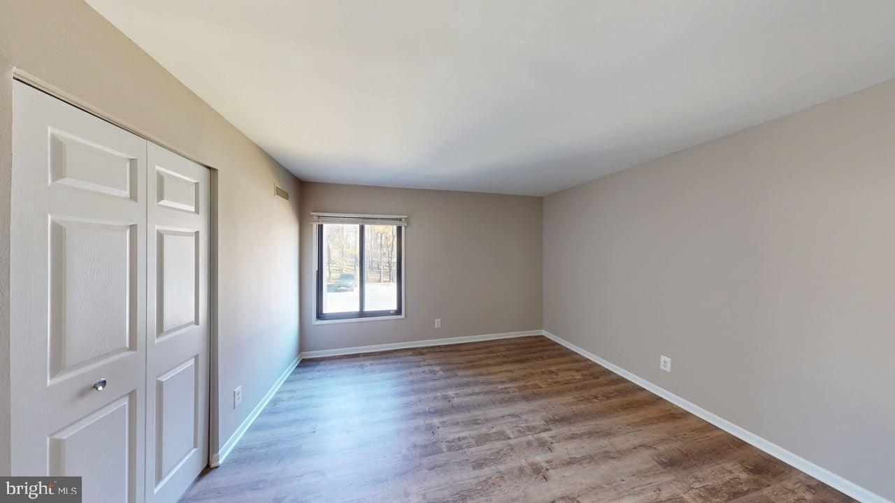 10114 Campus Way South, Unit 201 8C Upper Marlboro, MD 20774 - Photo 10 of 17 wooden floor in an empty room with a window