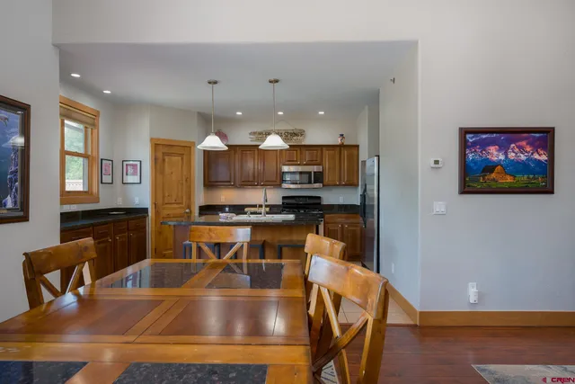 a view of kitchen with dining table and chairs