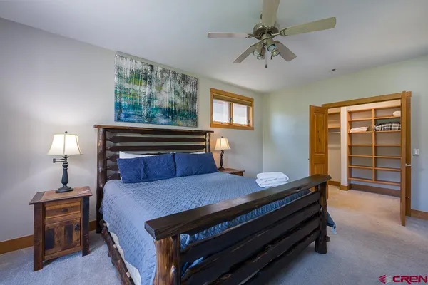 a bedroom with a bed and a chandelier