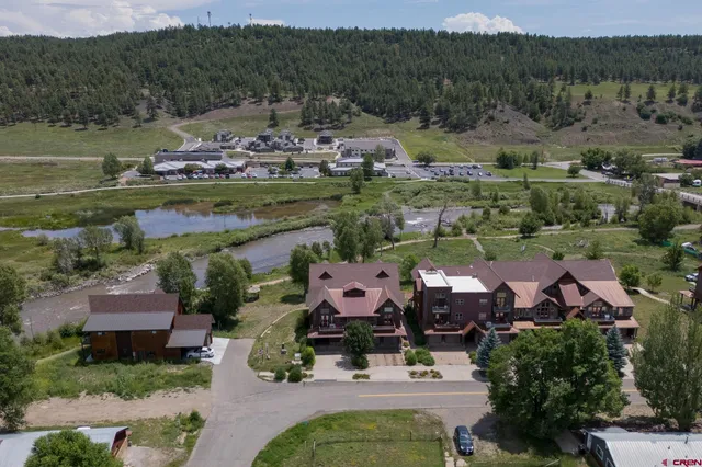 an aerial view of a house with a lake view