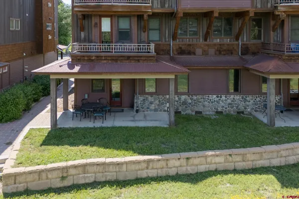 a view of a house with a yard porch and sitting area