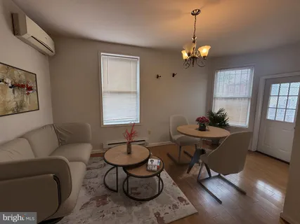 a living room with furniture a window and a chandelier