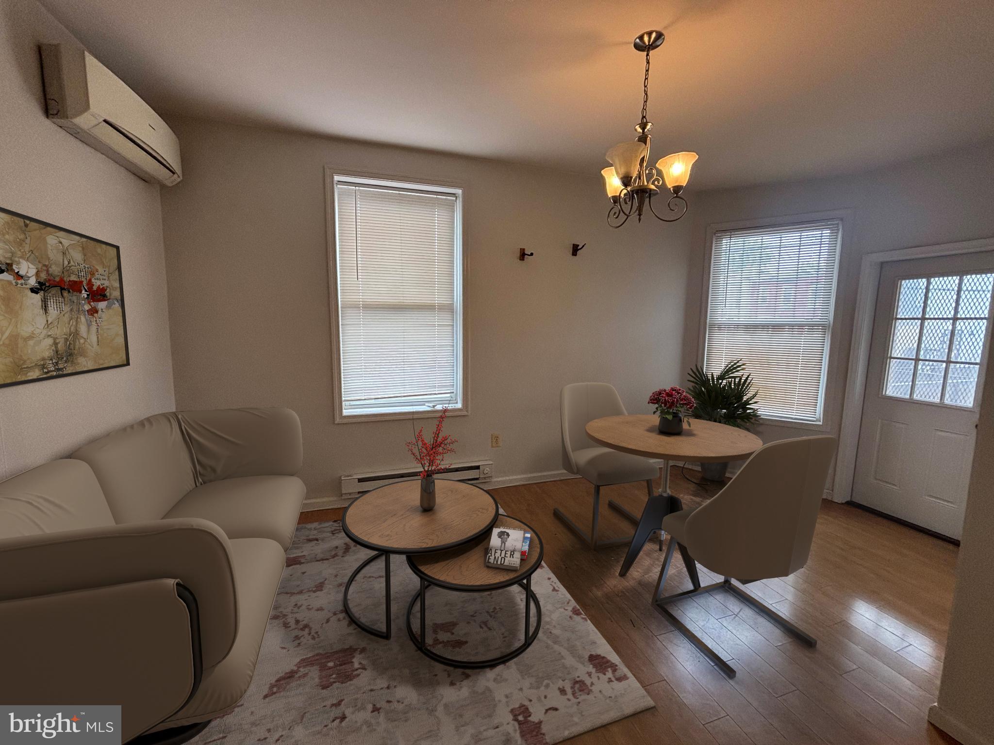 a living room with furniture a window and a chandelier